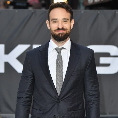 Charlie Cox wears a suit in a event